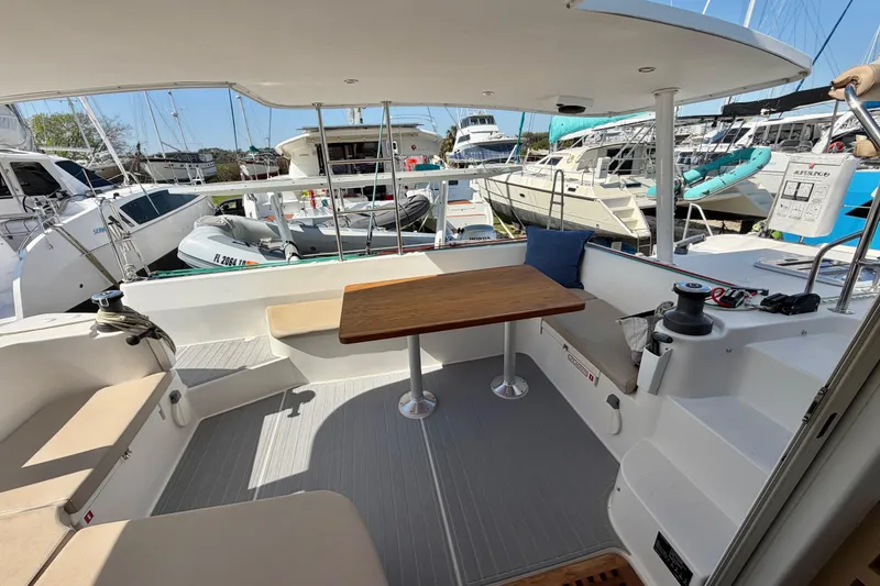 Slide: The Image of 2014 Outremer 45 catamaran cockpit with seating, table, and marina view. - 9