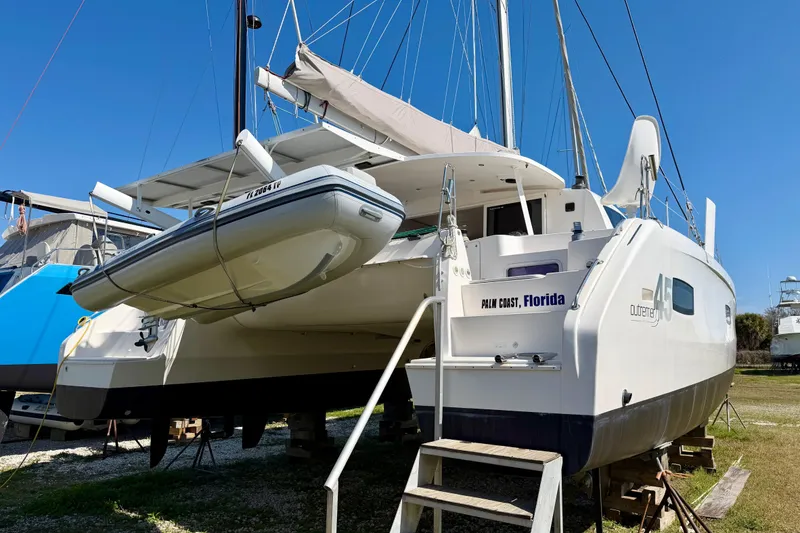 Slide: The Image of 2014 Outremer 45 catamaran in dry dock, Palm Coast, Florida, with inflatable dinghy. - 91