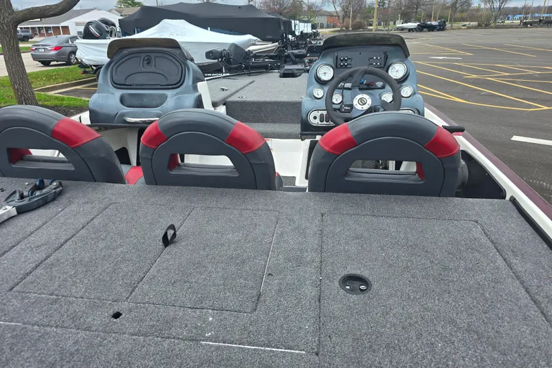 Slide: The Image of 2011 Nitro Z-7 boat interior with steering console and seating in a parking lot. - 5