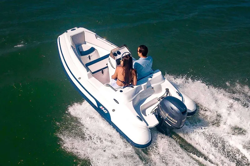 Slide: The Image of Manufacturer Provided Image: 2026 AB Inflatables Nautilus 13 DLX on water with two people. - 2