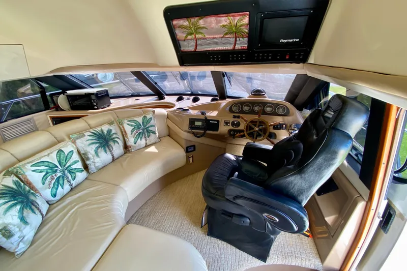 Slide: The Image of Luxurious interior of 2000 Carver 450 Voyager Pilothouse with plush seating and helm. - 65