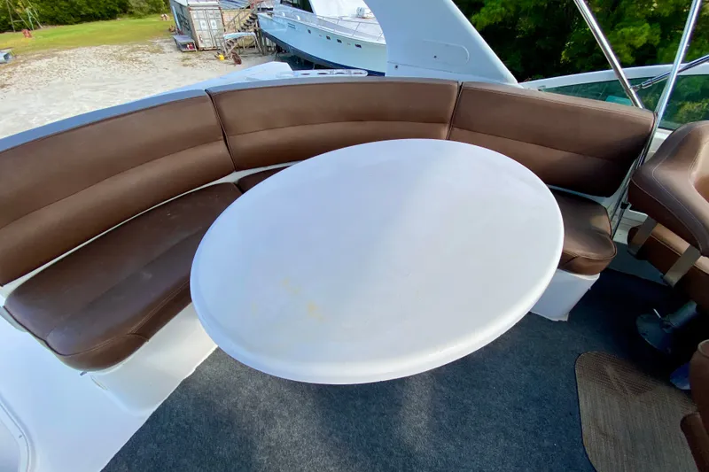 Slide: The Image of Brown seating and white table on 2000 Carver 450 Voyager Pilothouse yacht deck. - 99