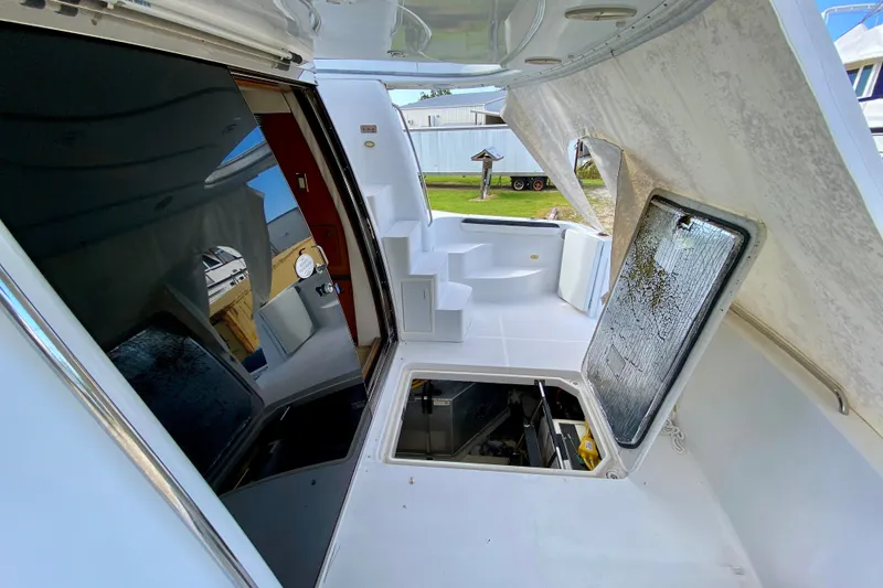 Slide: The Image of 2000 Carver 450 Voyager Pilothouse yacht interior with open hatch and seating area. - 85