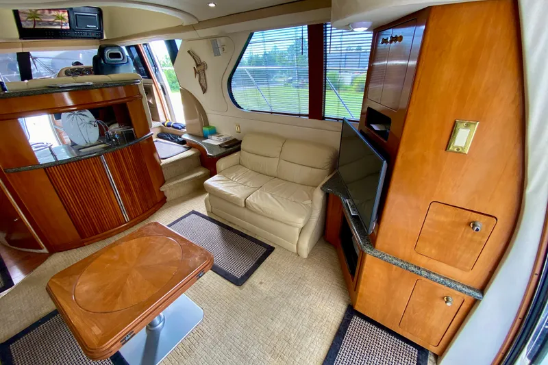 Slide: The Image of Interior of 2000 Carver 450 Voyager Pilothouse with leather seating and wooden cabinetry. - 28