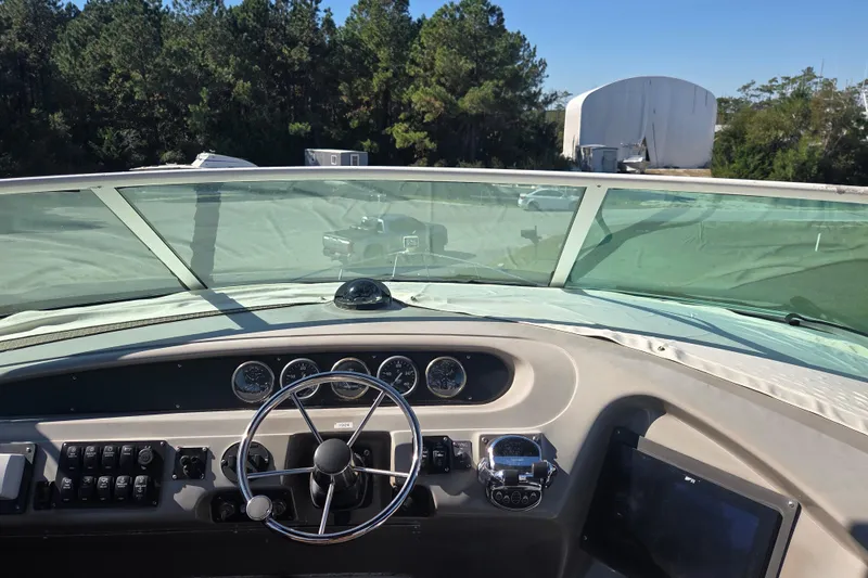 Slide: The Image of 2000 Carver 450 Voyager Pilothouse helm with steering wheel and instrument panel. - 21