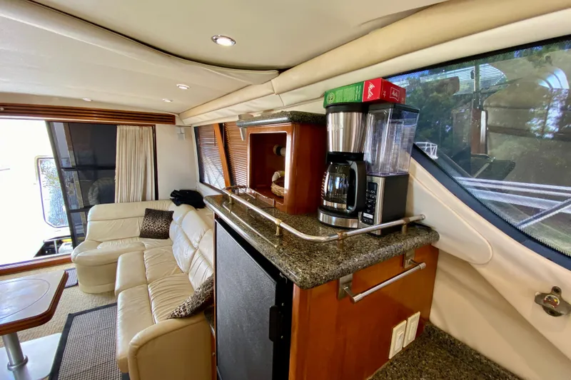 Slide: The Image of Luxurious interior of 2000 Carver 450 Voyager Pilothouse with leather seating and coffee maker. - 57