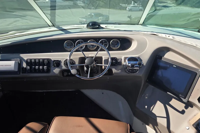 Slide: The Image of Pilothouse interior of 2000 Carver 450 Voyager, featuring steering wheel and control panel. - 22