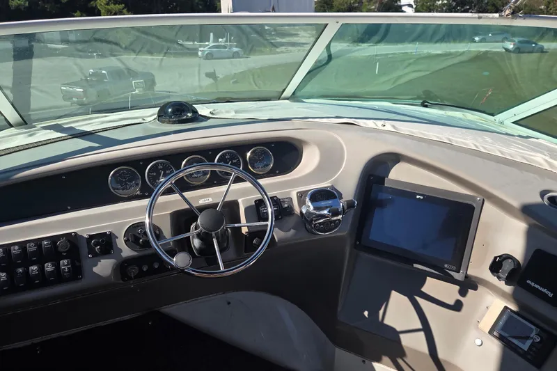 Slide: The Image of Pilothouse interior of 2000 Carver 450 Voyager with steering wheel and navigation controls. - 23