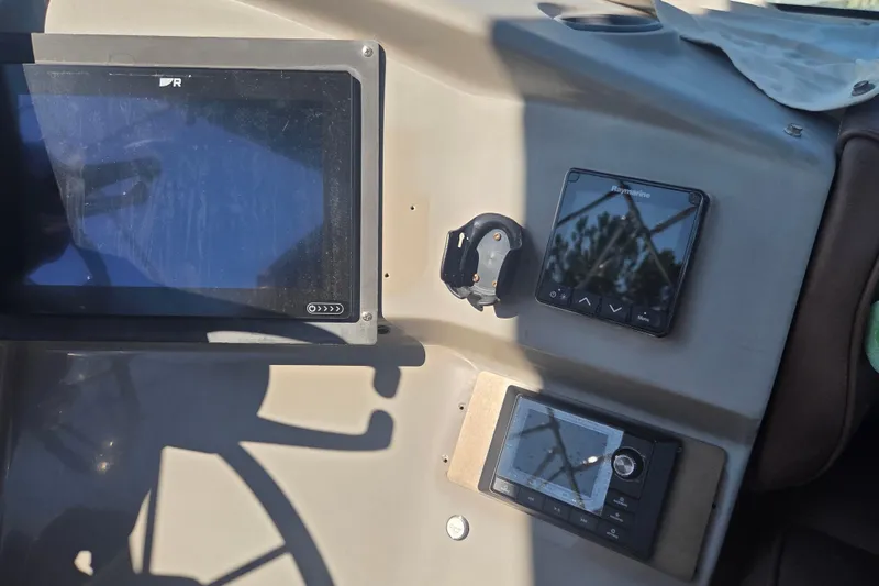 Slide: The Image of Control panel of a 2000 Carver 450 Voyager Pilothouse with navigation equipment. - 24