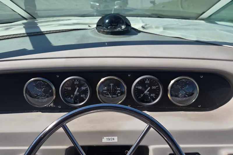 Slide: The Image of Dashboard of a 2000 Carver 450 Voyager Pilothouse with gauges and steering wheel. - 26