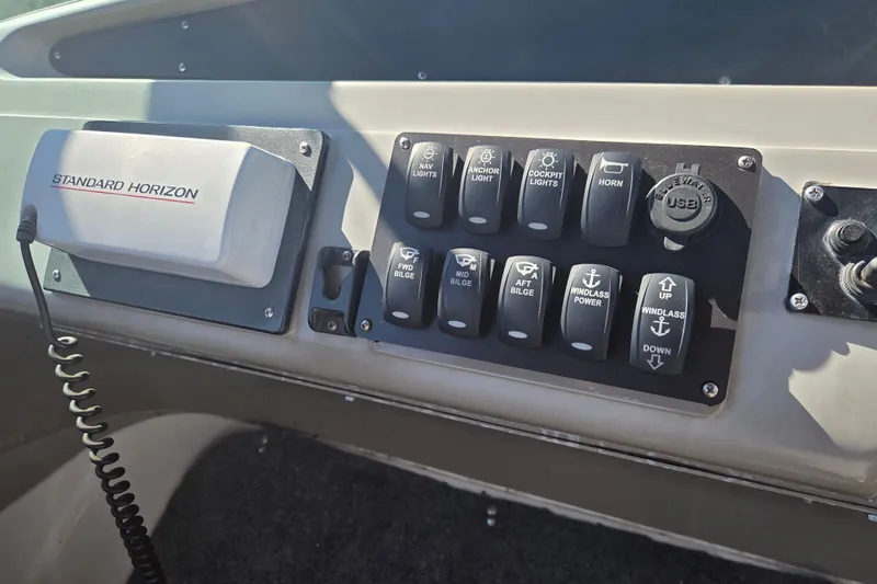 Slide: The Image of Control panel of a 2000 Carver 450 Voyager Pilothouse with various switches and USB port. - 27