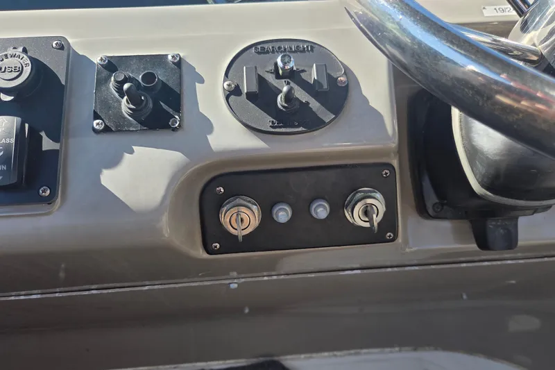 Slide: The Image of Control panel of a 2000 Carver 450 Voyager Pilothouse boat with steering wheel. - 28