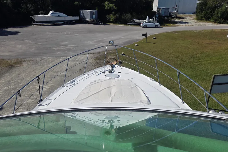 Slide: The Image of 2000 Carver 450 Voyager Pilothouse yacht docked, view from helm, surrounded by greenery. - 35