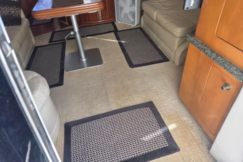 Slide: The Image of Interior of 2000 Carver 450 Voyager Pilothouse with seating, table, and carpeted floor. - 37