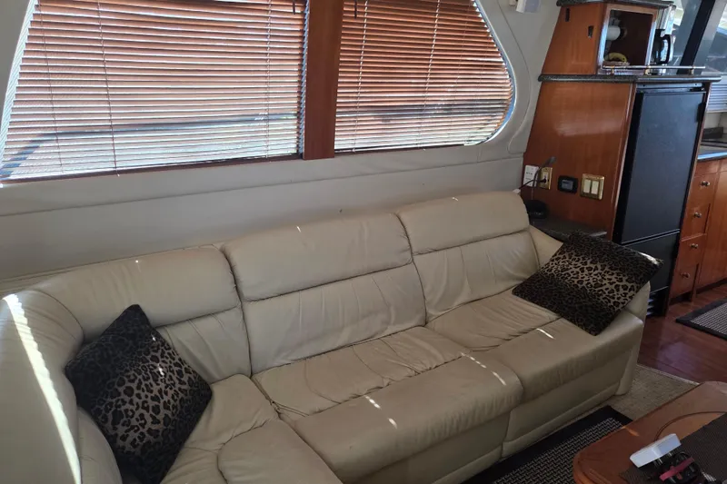 Slide: The Image of Interior of 2000 Carver 450 Voyager Pilothouse with beige sofa and leopard print pillows. - 38
