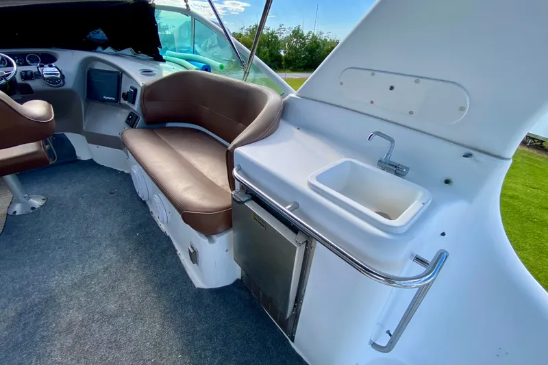 Slide: The Image of Interior of 2000 Carver 450 Voyager Pilothouse with seating and sink area. - 93