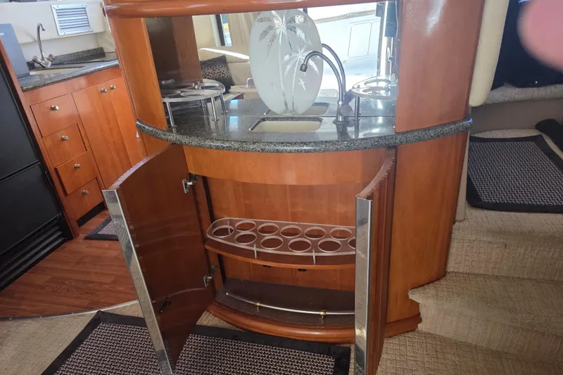 Slide: The Image of Interior of 2000 Carver 450 Voyager Pilothouse with open cabinet and decorative vase. - 42