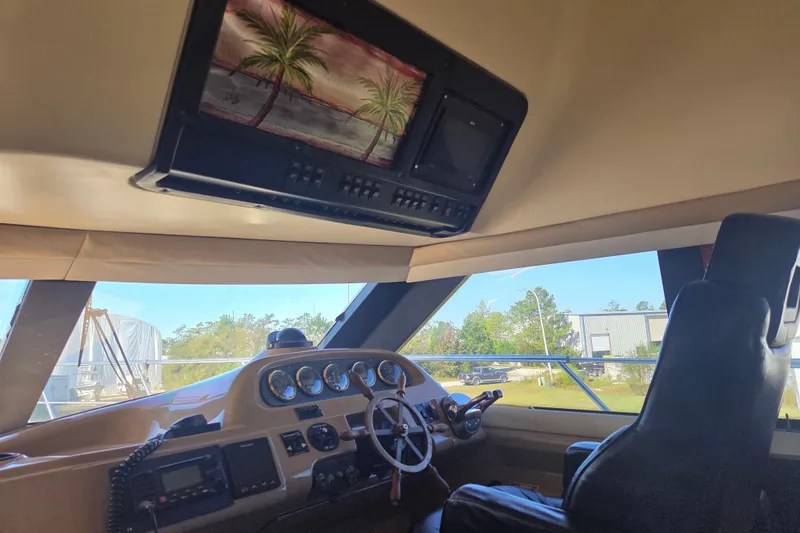 Slide: The Image of Interior of 2000 Carver 450 Voyager Pilothouse with steering wheel and control panel. - 45