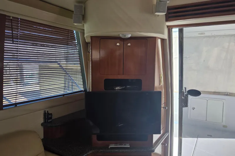 Slide: The Image of Interior of 2000 Carver 450 Voyager Pilothouse with TV, cabinets, and window blinds. - 47