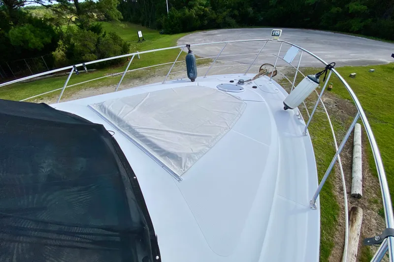 Slide: The Image of 2000 Carver 450 Voyager Pilothouse yacht deck with railing and protective cover. - 77