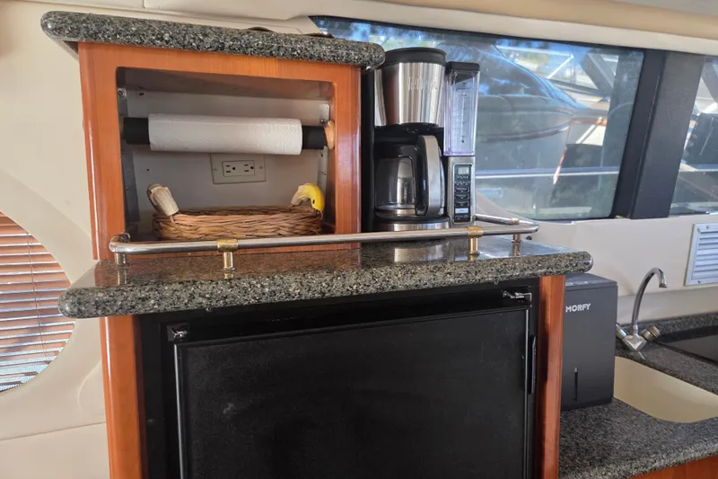 Slide: The Image of Carver 450 Voyager Pilothouse 2000 yacht kitchen with coffee maker and granite countertop. - 53