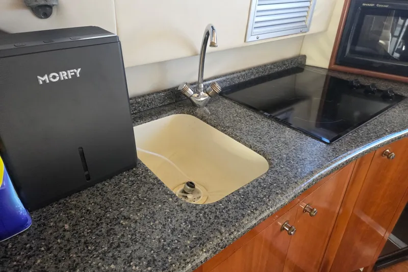 Slide: The Image of Kitchen area of 2000 Carver 450 Voyager Pilothouse with sink and stove. - 55