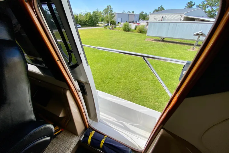 Slide: The Image of Interior view from 2000 Carver 450 Voyager Pilothouse, showing open door to grassy area. - 71