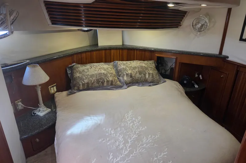 Slide: The Image of Cozy bedroom in 2000 Carver 450 Voyager Pilothouse with elegant bedding and wooden accents. - 58