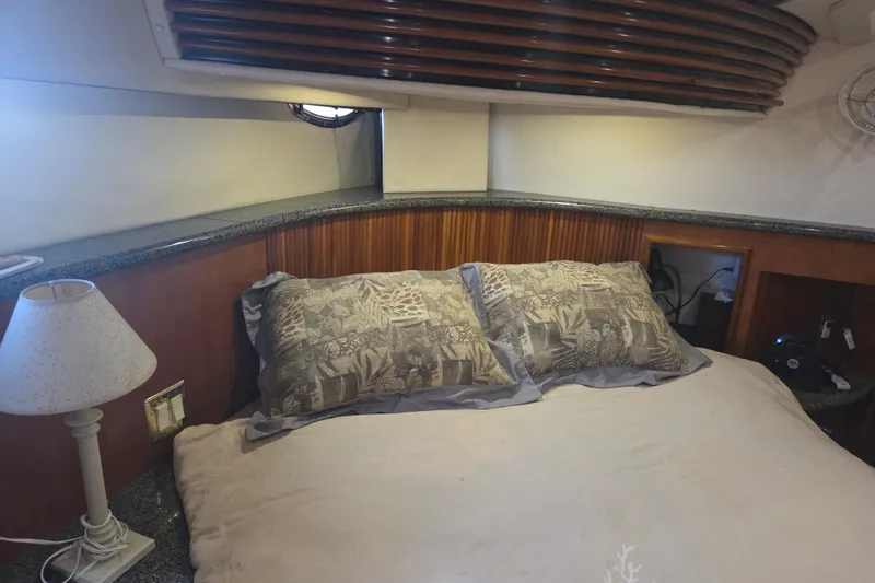 Slide: The Image of Cozy bedroom in 2000 Carver 450 Voyager Pilothouse yacht with elegant wood paneling. - 59