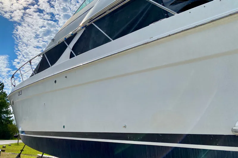 Slide: The Image of 2000 Carver 450 Voyager Pilothouse yacht under a partly cloudy sky. - 13