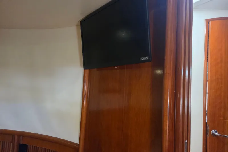Slide: The Image of Interior of 2000 Carver 450 Voyager Pilothouse with mounted Vizio TV and wooden paneling. - 61