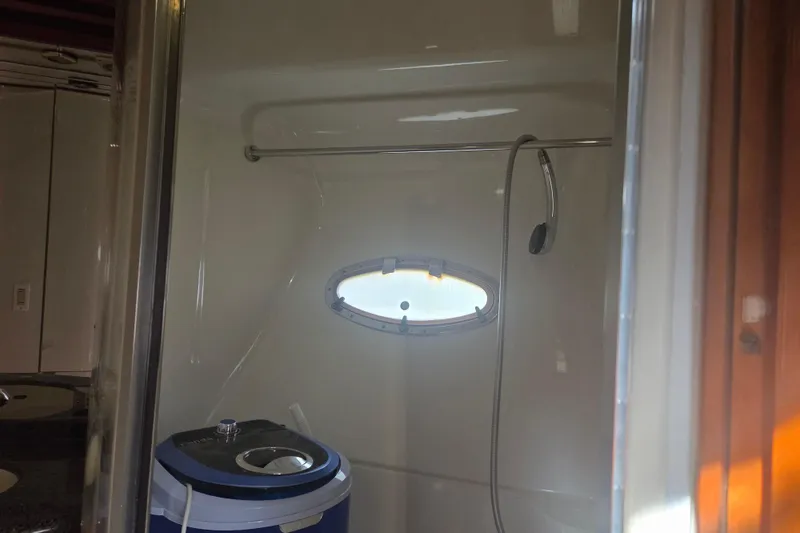 Slide: The Image of Interior of 2000 Carver 450 Voyager Pilothouse bathroom with shower and porthole window. - 63