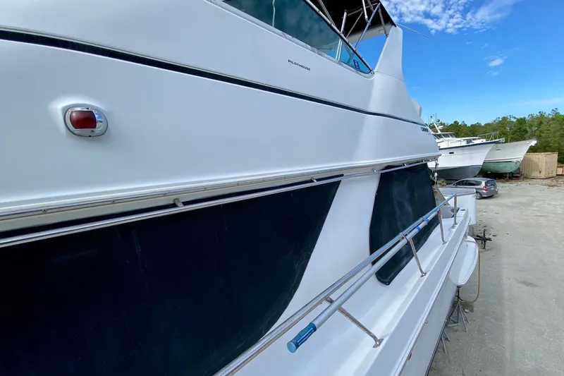 Slide: The Image of 2000 Carver 450 Voyager Pilothouse yacht docked on land, side view. - 81