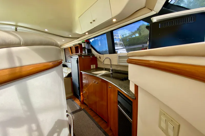 Slide: The Image of Interior of 2000 Carver 450 Voyager Pilothouse yacht with modern kitchen amenities. - 55