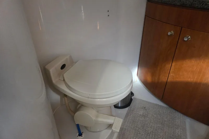 Slide: The Image of Bathroom interior of 2000 Carver 450 Voyager Pilothouse with toilet and wooden cabinet. - 66