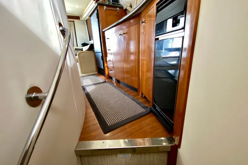 Slide: The Image of Interior of 2000 Carver 450 Voyager Pilothouse with wooden cabinetry and modern appliances. - 54