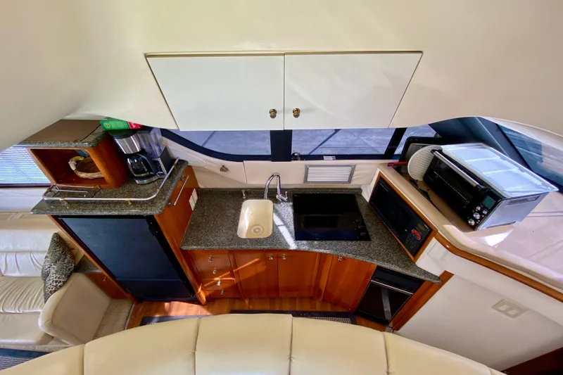 Slide: The Image of Interior of 2000 Carver 450 Voyager Pilothouse kitchen with appliances and cabinetry. - 69