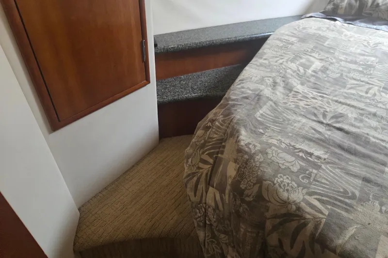 Slide: The Image of Interior of 2000 Carver 450 Voyager Pilothouse with bed, steps, and wooden cabinet. - 71