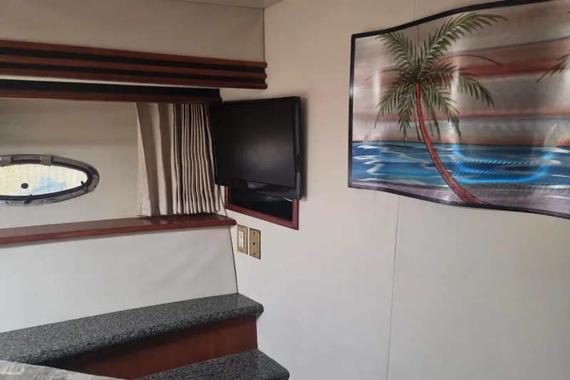 Slide: The Image of Interior of 2000 Carver 450 Voyager Pilothouse with TV and tropical wall art. - 73