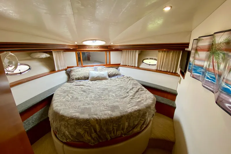 Slide: The Image of Luxurious bedroom interior of 2000 Carver 450 Voyager Pilothouse yacht with cozy bedding. - 35