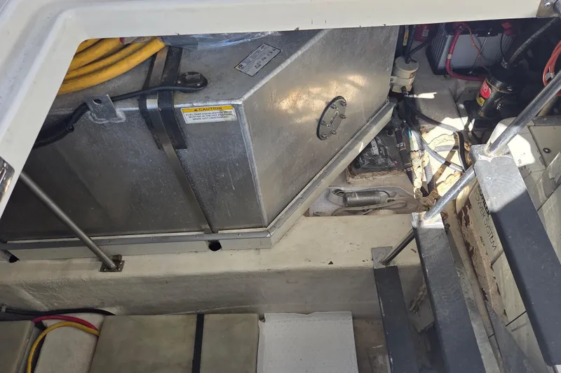 Slide: The Image of Engine compartment of a 2000 Carver 450 Voyager Pilothouse with visible fuel tank and wiring. - 79