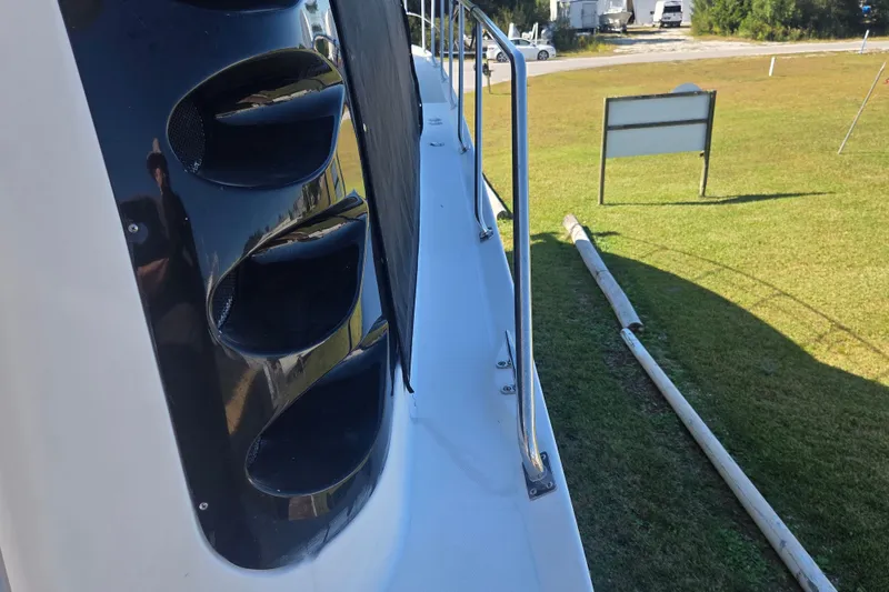 Slide: The Image of Side view of 2000 Carver 450 Voyager Pilothouse yacht on grassy area. - 8