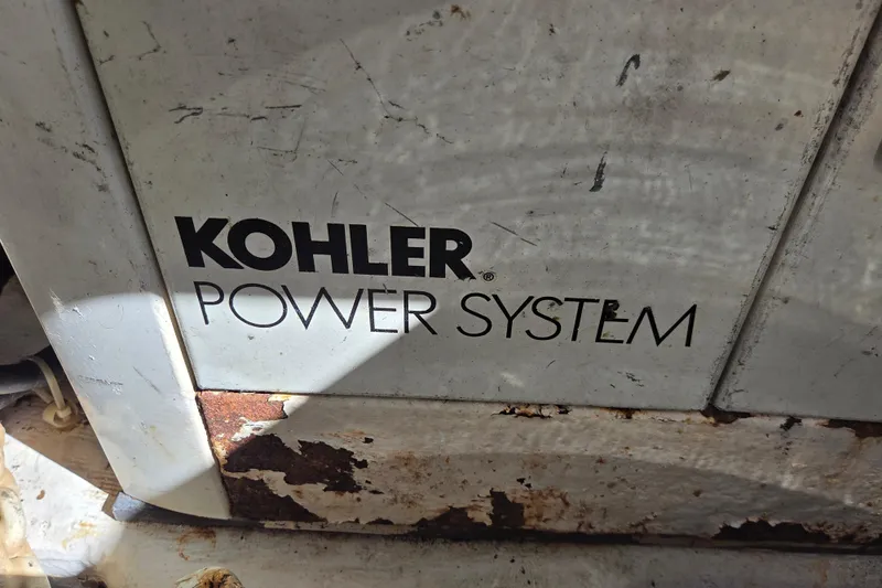 Slide: The Image of Kohler power system on 2000 Carver 450 Voyager Pilothouse, showing rust and wear. - 80