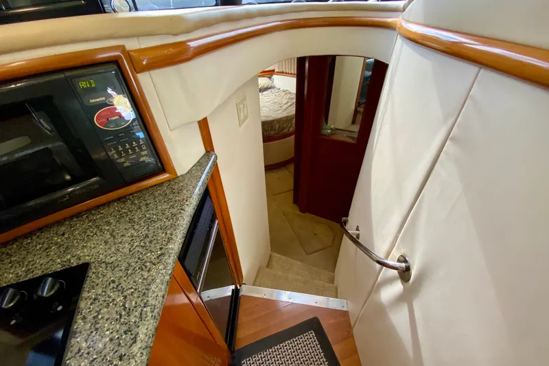 Slide: The Image of Interior of 2000 Carver 450 Voyager Pilothouse with stairs, microwave, and bedroom view. - 33