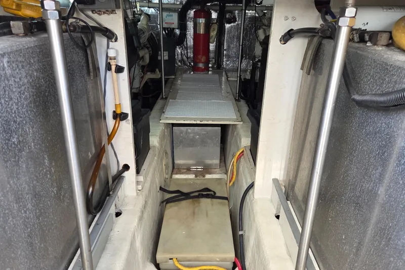 Slide: The Image of Engine room of 2000 Carver 450 Voyager Pilothouse with visible equipment and wiring. - 84