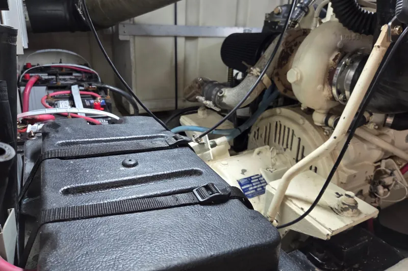 Slide: The Image of Engine room of 2000 Carver 450 Voyager Pilothouse with visible battery and machinery components. - 86