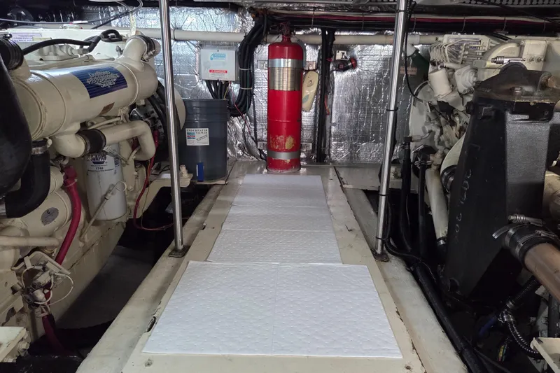 Slide: The Image of Engine room of 2000 Carver 450 Voyager Pilothouse with visible machinery and fire extinguisher. - 87
