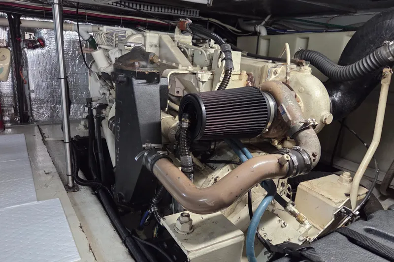 Slide: The Image of Engine room of a 2000 Carver 450 Voyager Pilothouse yacht, showcasing mechanical components. - 88