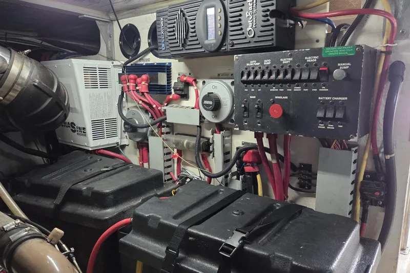 Slide: The Image of Engine room of 2000 Carver 450 Voyager Pilothouse with electrical panel and battery setup. - 89