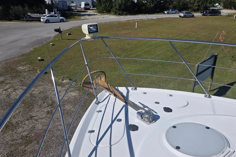 Slide: The Image of Bow view of 2000 Carver 450 Voyager Pilothouse yacht with anchor and railing. - 9